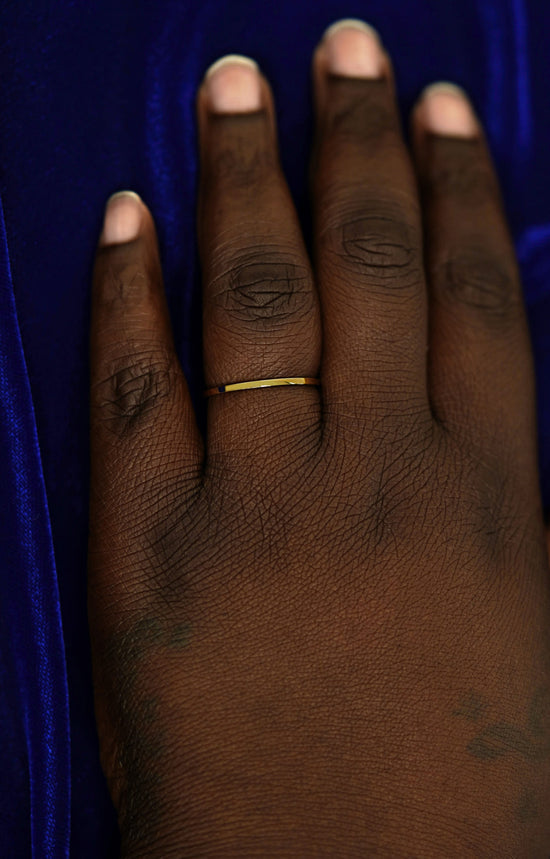 A hand wearing a 1.7mm band in size 14