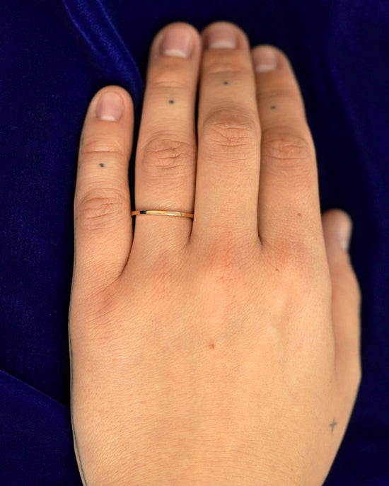 A hand wearing a 1.7mm band in size 6.5