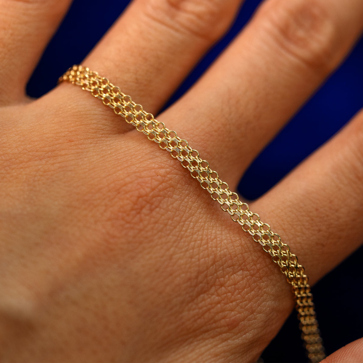 A yellow gold Bismark Chain on the back of a model's hand to show the details of the links