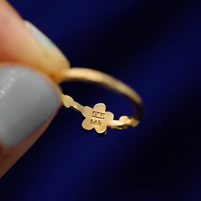 Underside view of a solid 14k gold Sakura Ring