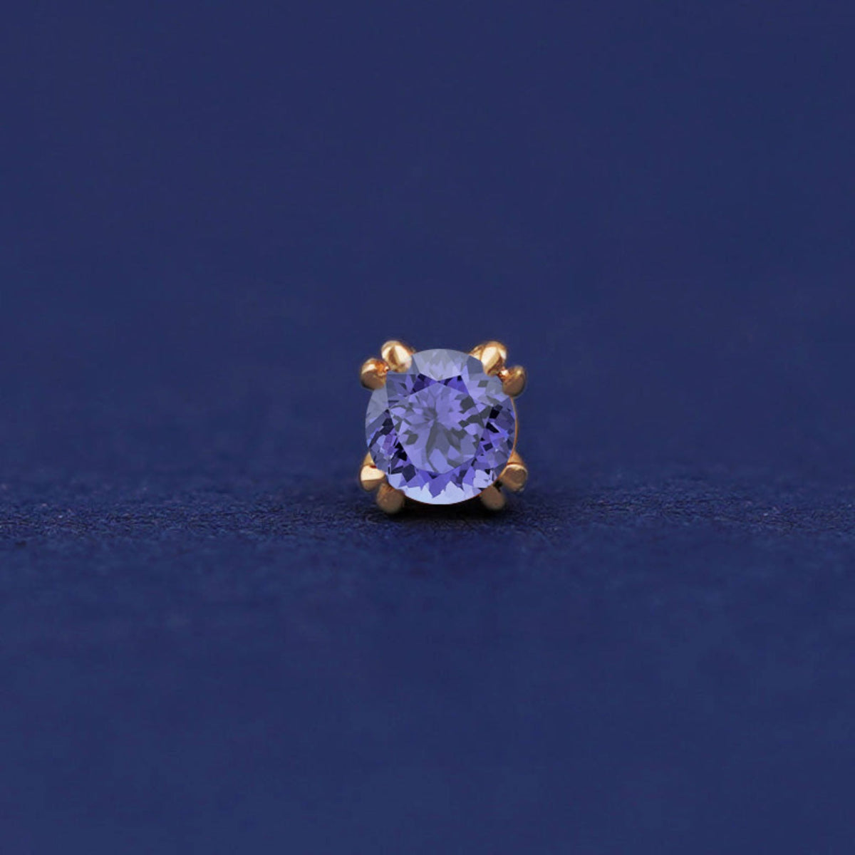 Front facing view of a 14k yellow gold Tanzanite Flat Back Earring