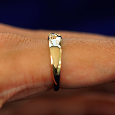 Side view of a Gemstone Claddagh Band on a model's finger