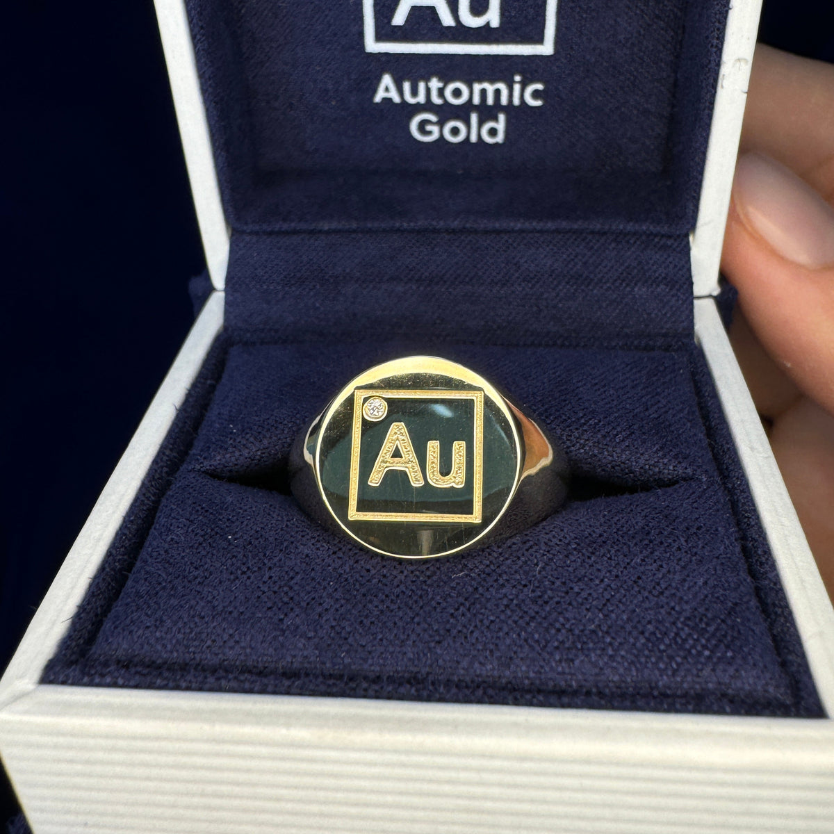 Yellow gold ring with AU engraving and round diamond