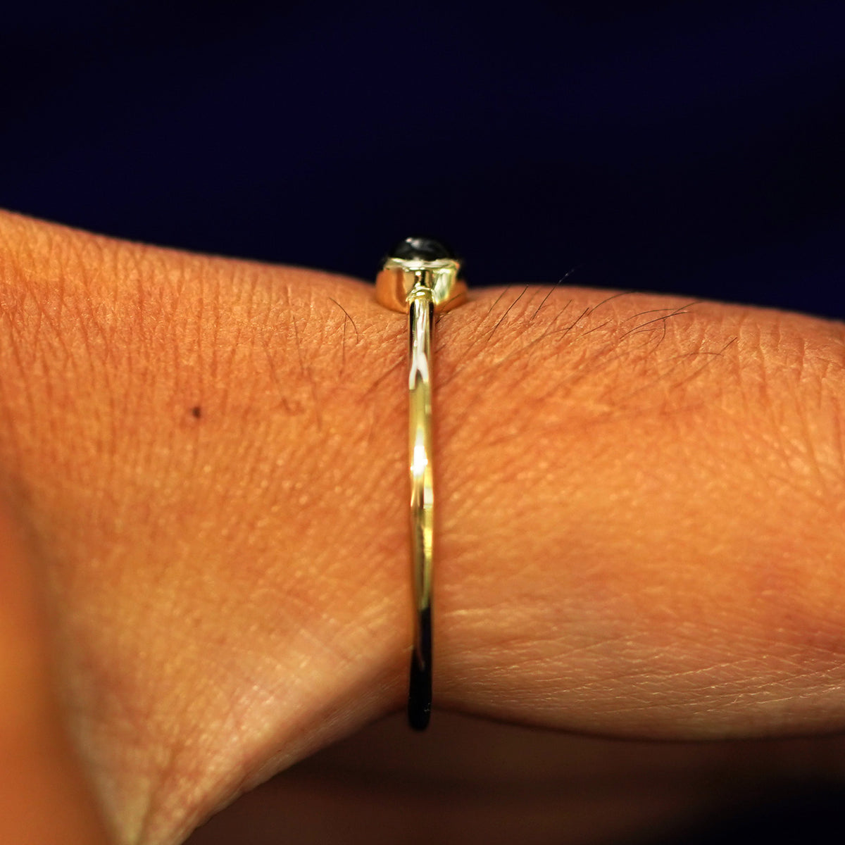 Side view of an Onyx Ring on a model's finger