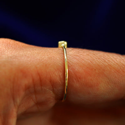 Side view of a Peridot Ring on a model's finger