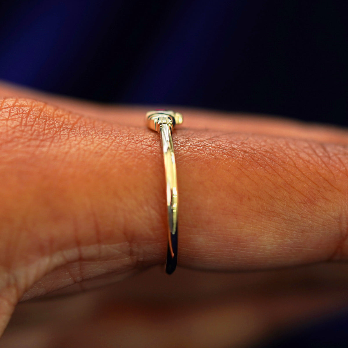Side view of a Thin Gemstone Claddagh Ring on a model's finger