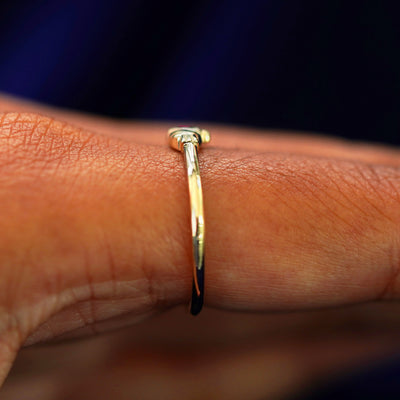 Side view of a Thin Gemstone Claddagh Ring on a model's finger