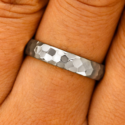 Close up view of a model's fingers wearing a Silver Curvy Hammered Band