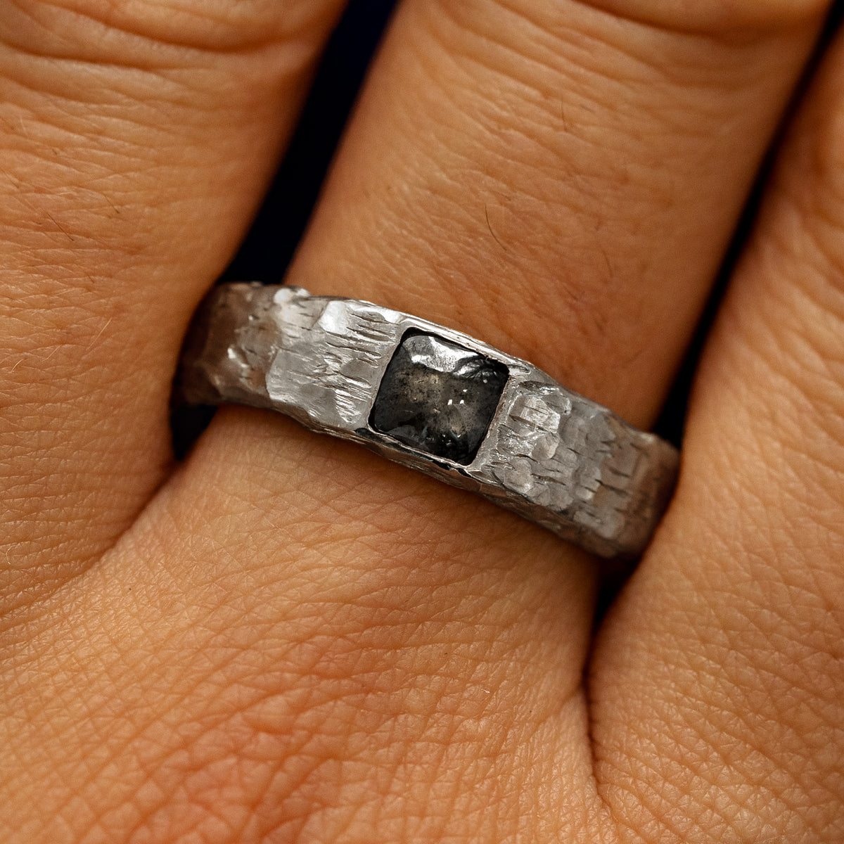 Close up view of a models fingers wearing a 925 Silver Square Diamond Organic Band