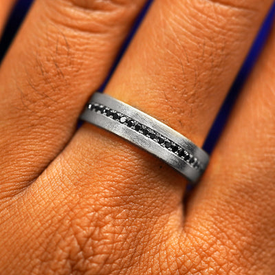 Close up view of a model's fingers wearing a 950 platinum Endless Diamond Band