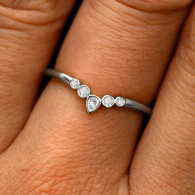Close up view of a model's fingers wearing a 950 platinum Chevron Tiara Diamond Band