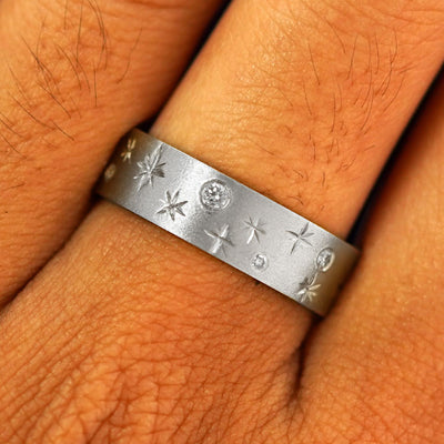 Close up view of a model's fingers wearing a 950 platinum Stars and Diamonds Band