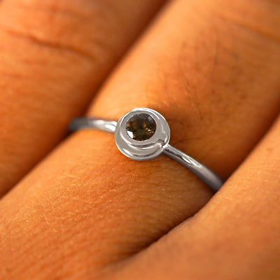 Close up view of a model's fingers wearing a platinum Coffee Cup Ring