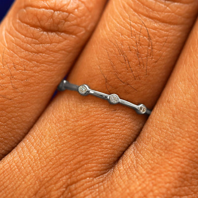 Close up view of a model's fingers wearing a 950 platinum Spaced Infinity Ring