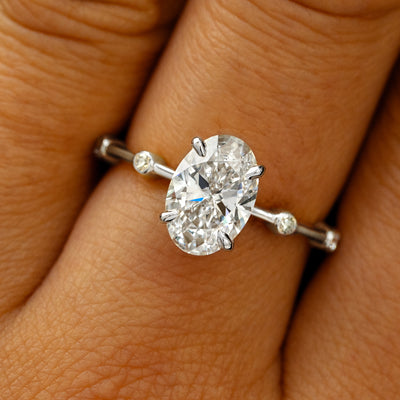 A solid 950 platinum Oval Lab Diamond Bubble Ring on a model's finger