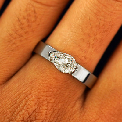 Close up view of a model's fingers wearing a 950 platinum Lab Diamond Pear Ring