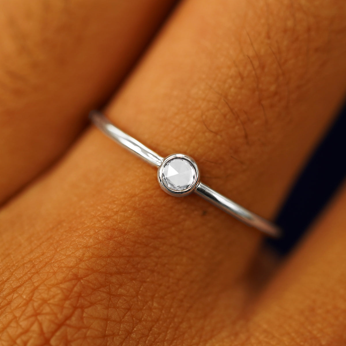 Close up view of a model's fingers wearing a 950 platinum Rose Cut Diamond Ring