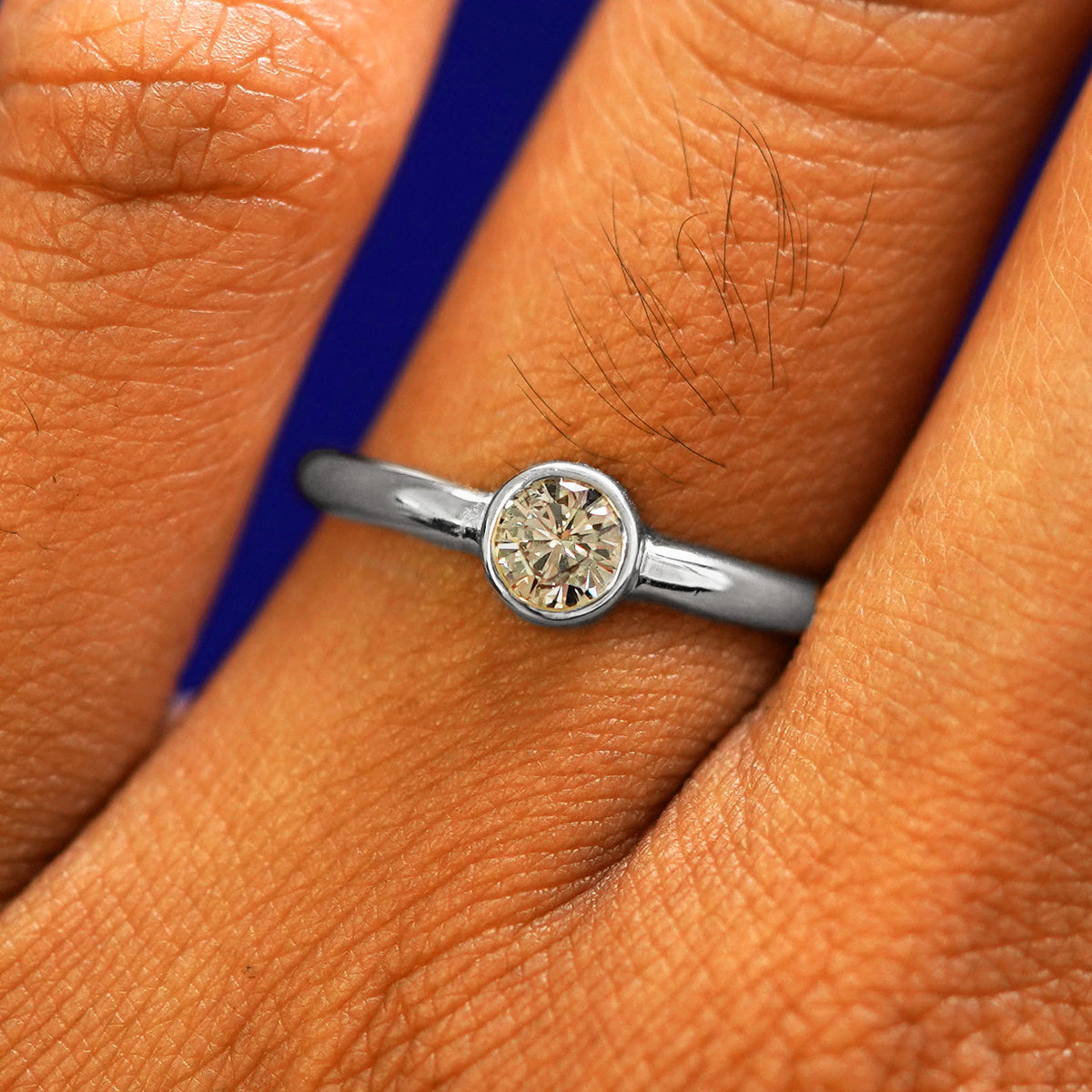 Close up view of a model's fingers wearing a 950 platinum 1/3ct Diamond Ring
