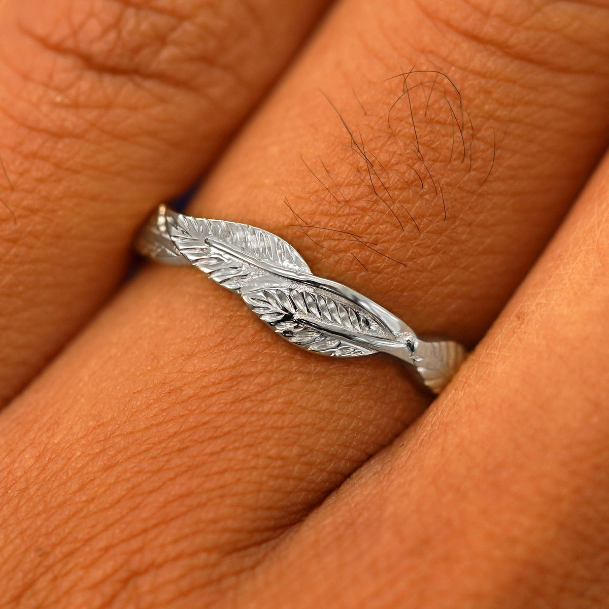 Close up view of a model's fingers wearing a 950 platinum Thick Leaves Band