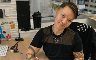 Automic Gold founder AL posing at their desk in our NYC studio