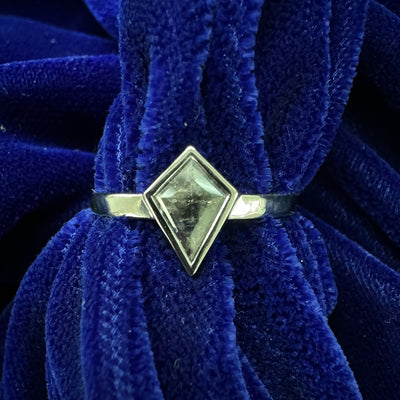 A kite shaped salt and pepper diamond solitaire on a 3mm platinum band