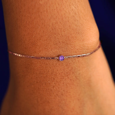 A model's wrist wearing a 14 karat rose gold Amethyst Bracelet