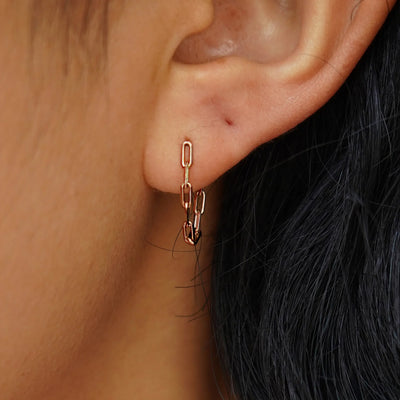 A model's ear wearing a rose gold Butch Chain Loop Earring
