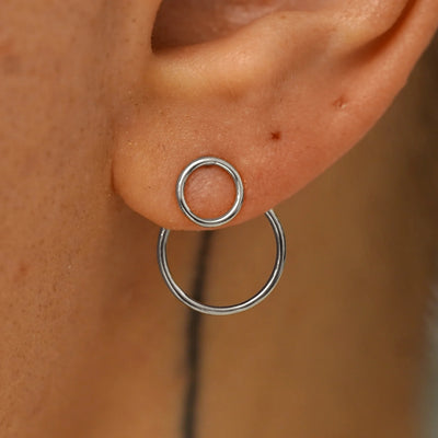 Close up view of a model's ear wearing a 14k white gold Open Circle Jacket with an Open Circle Earring