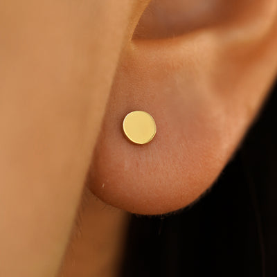 Close up view of a model's ear wearing a yellow gold Large Circle Earring
