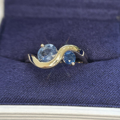 14k Yellow Gold with 0.73ct Light Blue Oval and 0.18ct Blue Round Sapphire set on 2.7mm Wavy Band Tapered to 3.7mm on the back Custom Ring, size 6.75