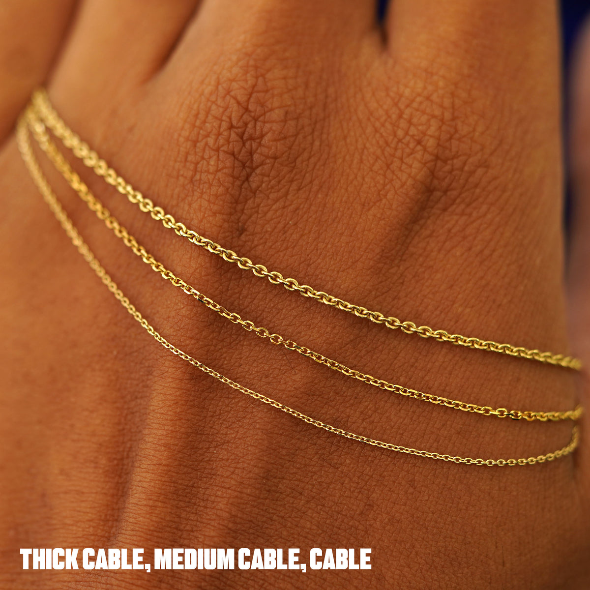 Thick Cable, Medium Cable, and classic Cable chains draped across the back of a model's hand to show difference in thickness