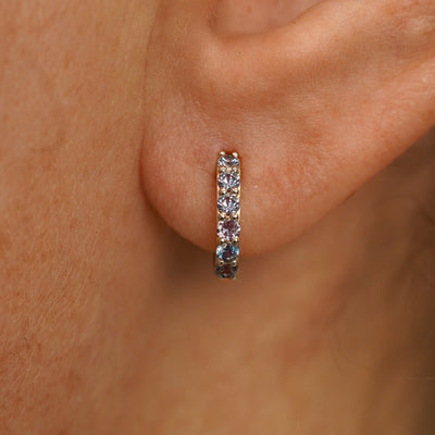 Close up view of a model's ear wearing a champagne gold Small Alexandrite Huggie Hoop
