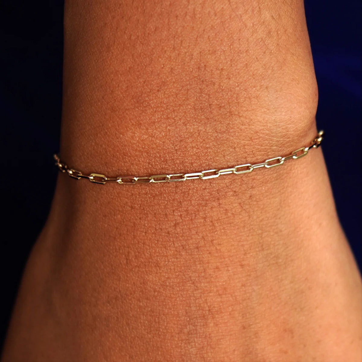 Close up view of a model's wrist wearing a solid champagne gold Butch Bracelet