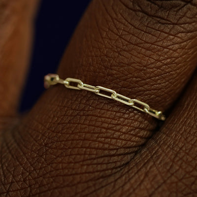 Close up view of a model's fingers wearing a 14k champagne gold Butch Chain Ring