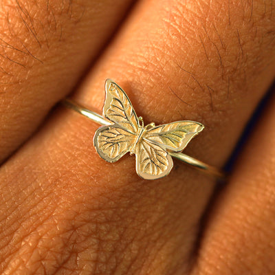 Close up view of a model's fingers wearing a champagne gold Butterfly Ring