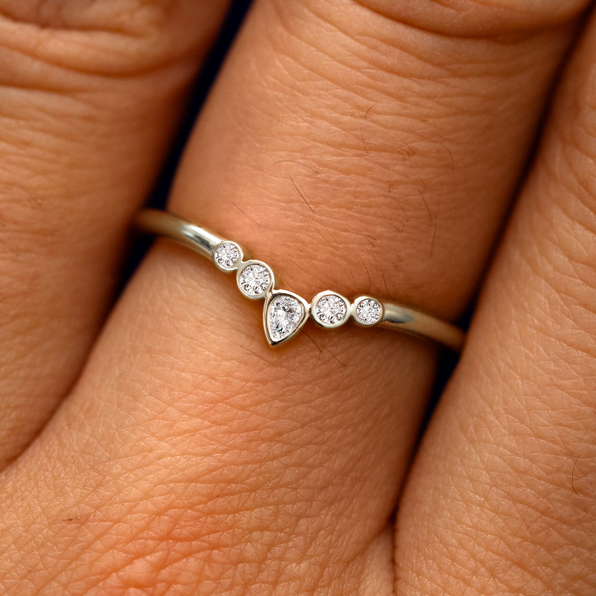 Close up view of a model's fingers wearing a 14k champagne gold Chevron Tiara Diamond Band