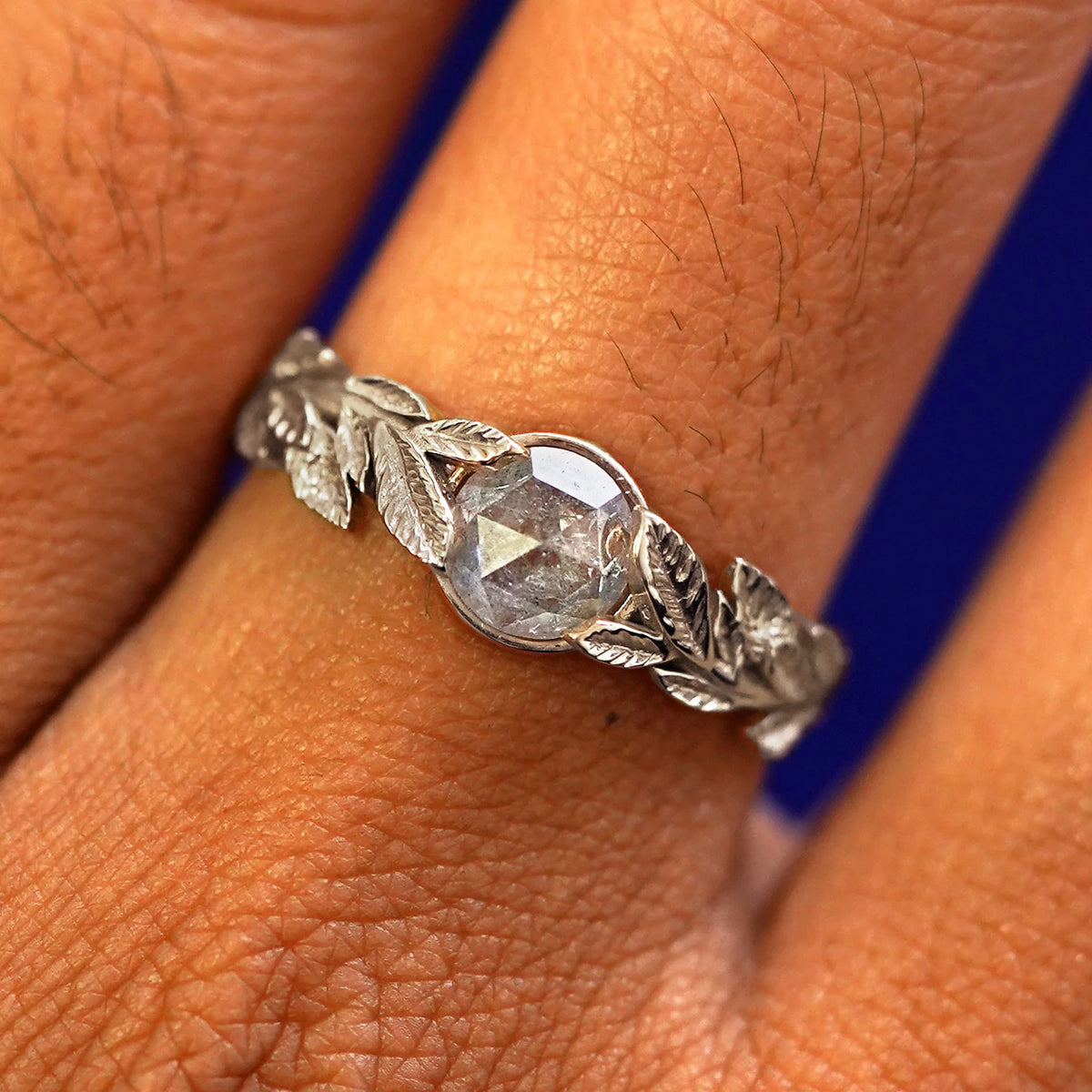 Close up view of a model's fingers wearing a 14k champagne gold Diamond Leaves Ring