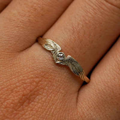 Close up view of a model's fingers wearing a 14k champagne gold Diamond Wings Ring