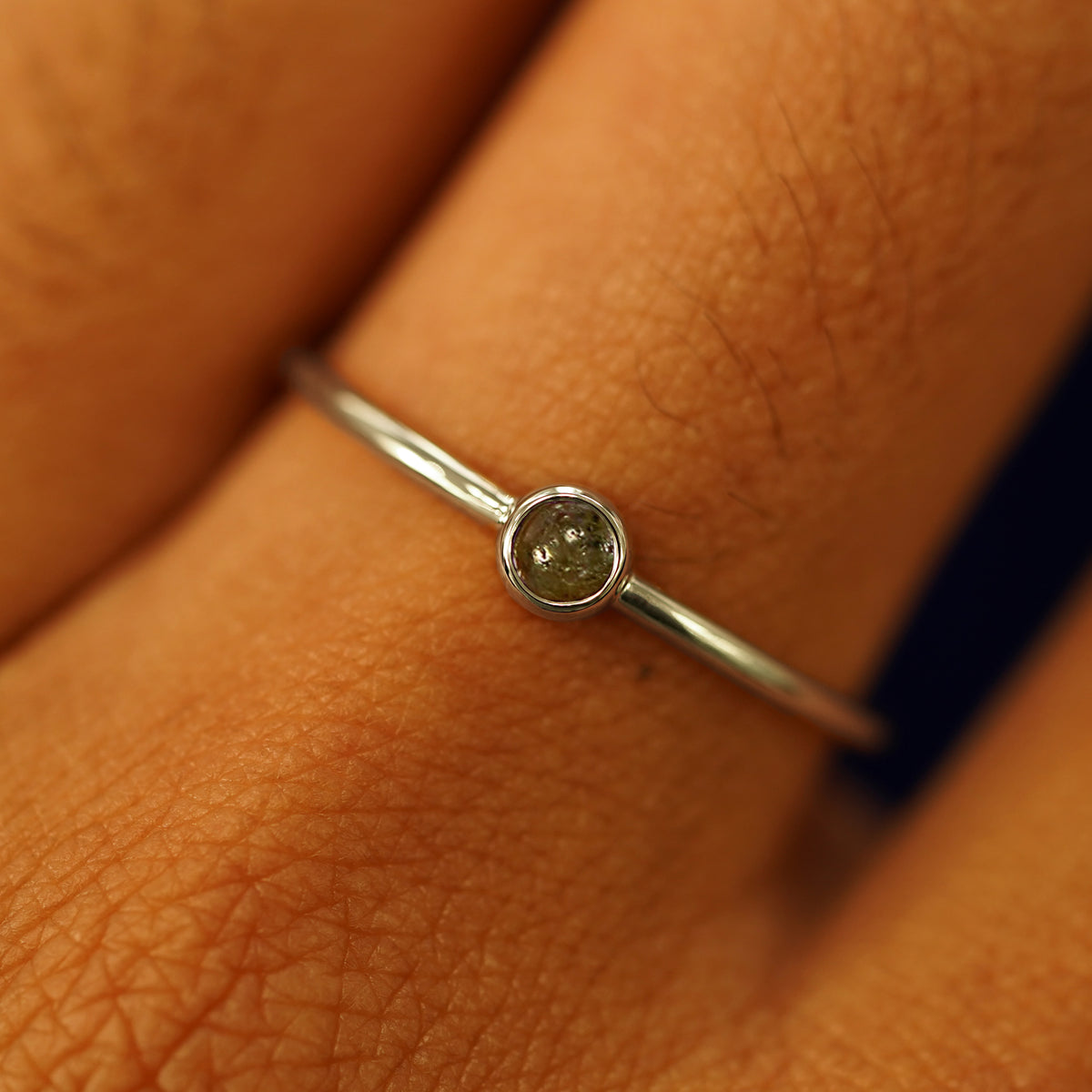 Close up view of a model's fingers wearing a 14k champagne gold Labradorite Ring