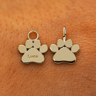 Two solid 14k champagne gold Paw Charms showing the for chain and the for earring options