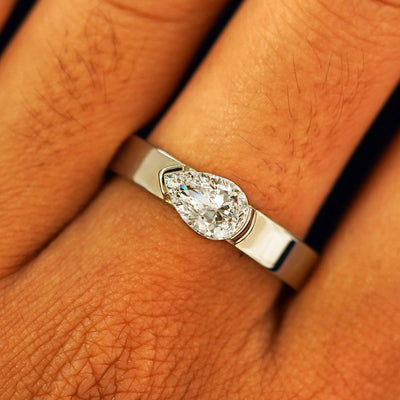 Close up view of a model's fingers wearing a 14k champagne gold Lab Diamond Pear Ring