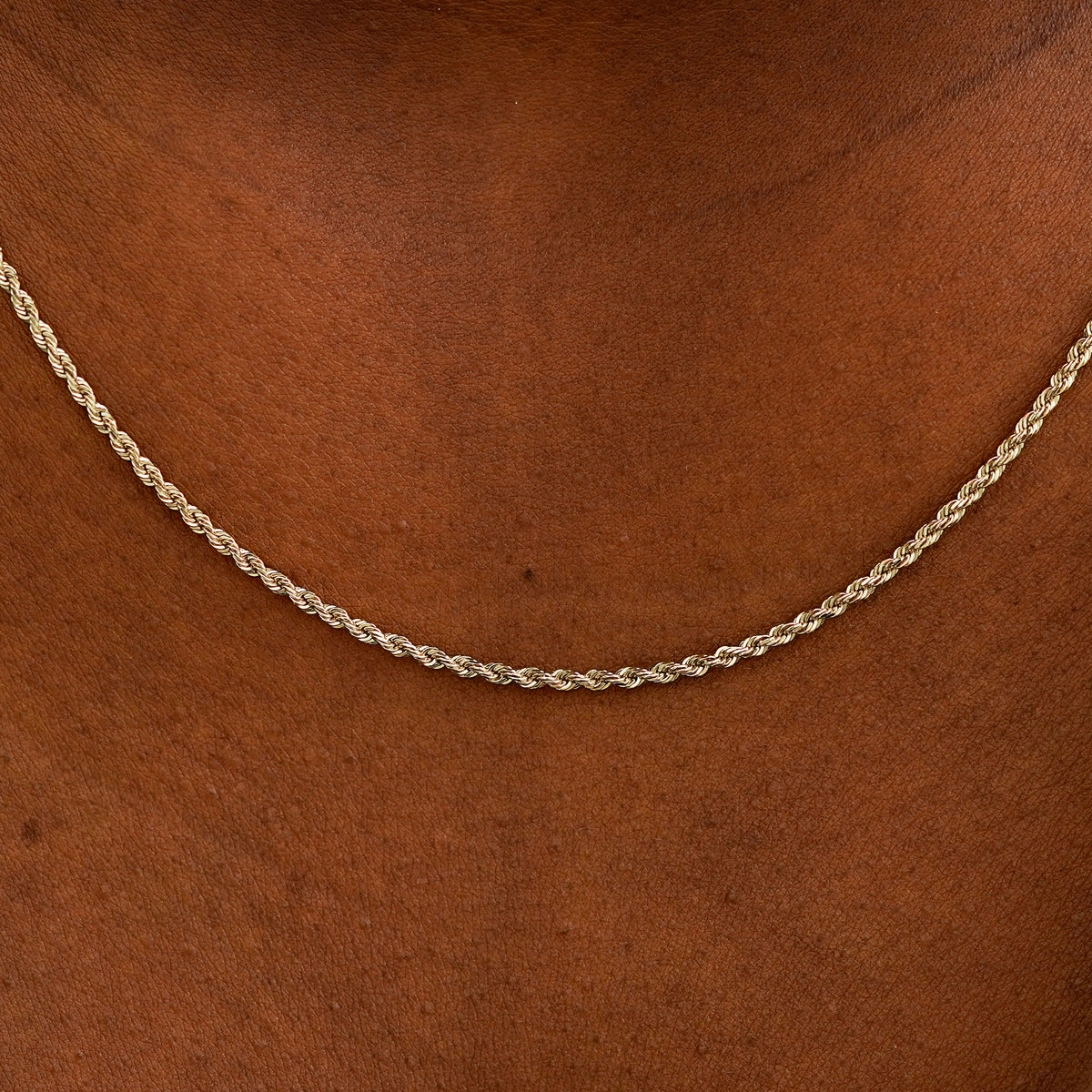 Close up view of a model's neck wearing a solid champagne gold Rope Chain