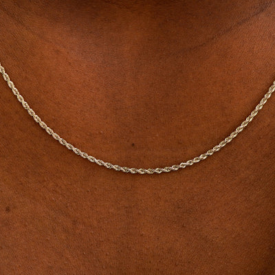 Close up view of a model's neck wearing a solid champagne gold Rope Chain