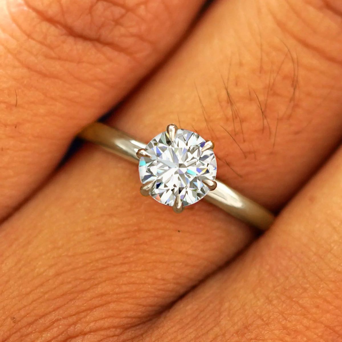 Close up view of a model's fingers wearing a 14k champagne gold Round Lab Diamond Ring