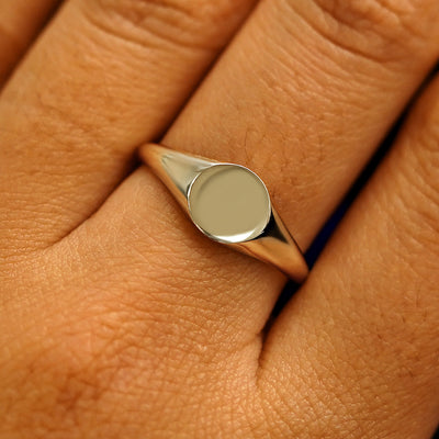 Close up view of a model's fingers wearing a 14k champagne gold Signet Ring