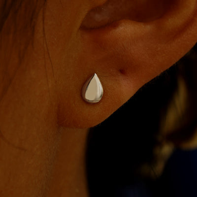Close up view of a model's ear wearing a champagne gold Teardrop Earring