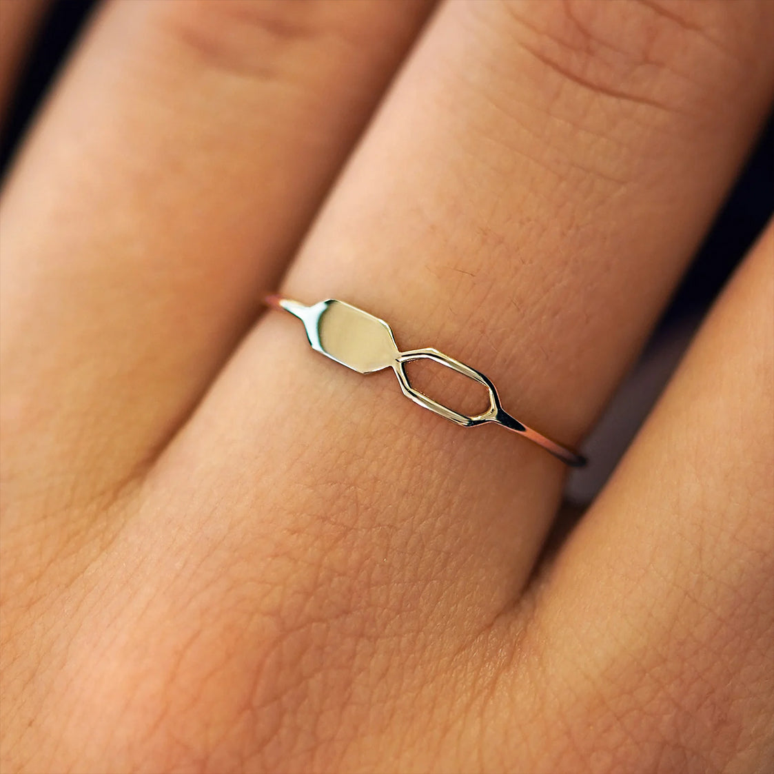 Close up view of a model's fingers wearing a 14k champagne gold Tanlah Ring