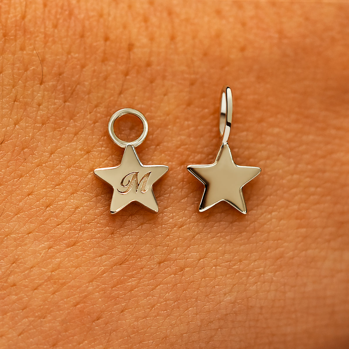 Two solid 14k champagne gold Star Charms showing the for chain and the for earring options