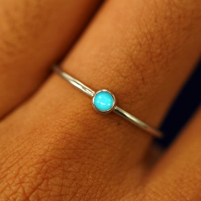 Close up view of a model's fingers wearing a 14k champagne gold Turquoise Ring