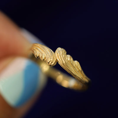 A model holding a Crashing Waves Band tilted to show the side of the band